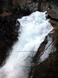 High angle view of waterfall along rocks
