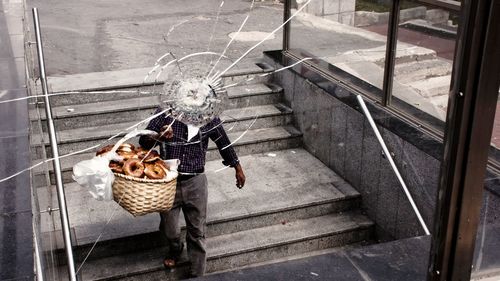 High angle view of man walking on staircase