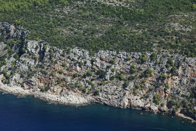High angle view of rocks by sea