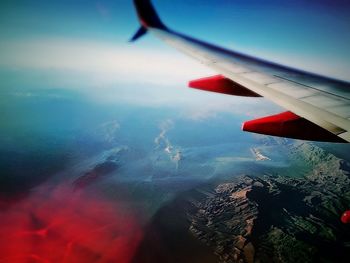 Close-up of airplane wing against sky