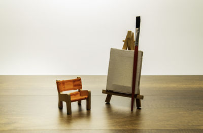 Close-up of art and craft equipments on table against white background