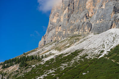 Low angle view of rock formations at tofana di rozes against sky