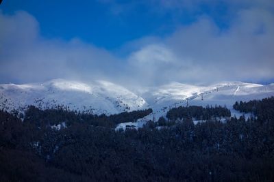 Scenic view of snow covered mountains against sky