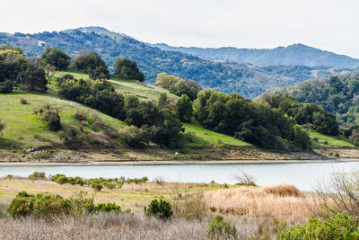 Scenic view of lake and mountains against sky