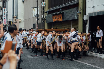 People standing on street in city