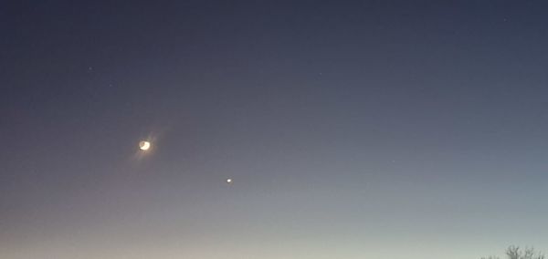 Low angle view of moon against sky at night