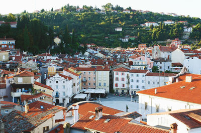 Red roofs of old town piran with main church against the sunrise sky, adriatic sea. slovenia