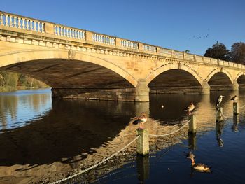 Bridge over river against clear sky