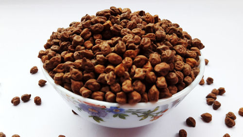 High angle view of coffee beans against white background