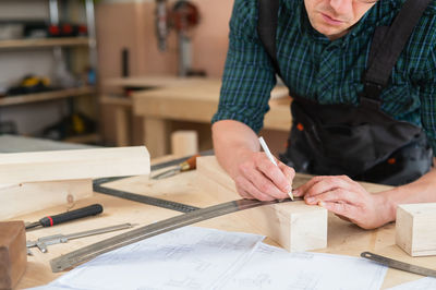 Midsection of man working in workshop