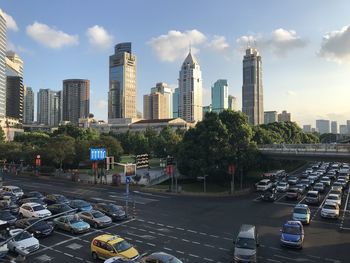 View of city street and buildings against sky