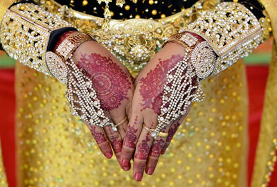 Midsection of bride with heena tattoo