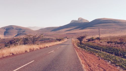 Country road leading towards mountains