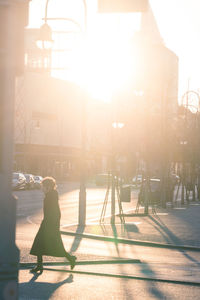 People on street against sky on sunny day