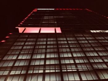 Low angle view of modern building against sky at night