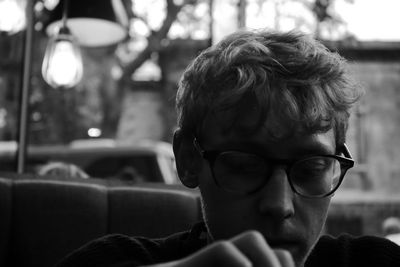 Close-up young man wearing eyeglasses standing outdoors