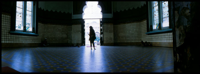 Rear view of people walking in building