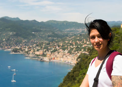 Portrait of young woman by sea