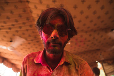Portrait of man in sunglasses covered with powder paint