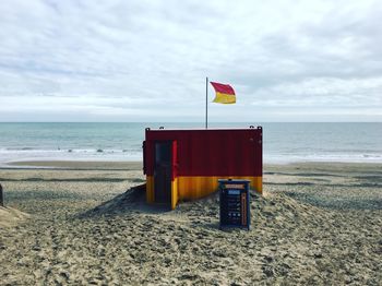 Lifeguard hut on beach against sky