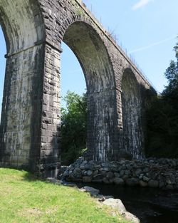 Low angle view of arch bridge against sky