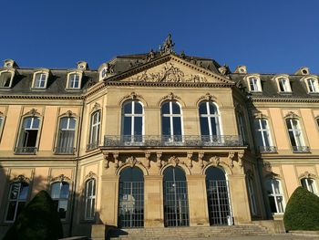 Low angle view of building against clear blue sky