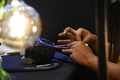 Close-up of hand holding candles