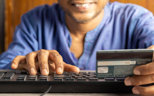 Midsection of man using laptop