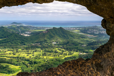 View through a rock window at the summit of pali puka hiking trail on oahu, hawaii, usa.