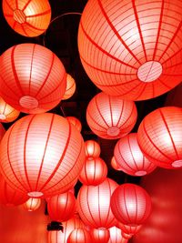 Low angle view of illuminated lanterns hanging at night