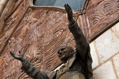 Low angle view of pope john paul ii statue at basilica del voto nacional