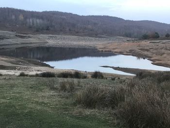 Scenic view of landscape and lake against sky