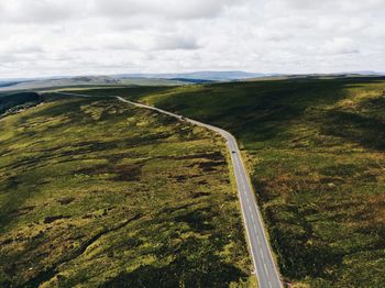 High angle view of road amidst land against sky