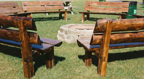 Empty chairs and table on field