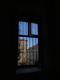 Low angle view of glass window in abandoned building