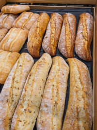 Variety of different types of french baguettes in a bakery or grocery store. freshly baked bread