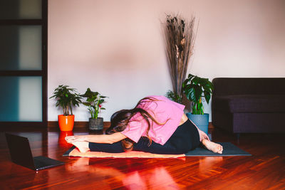 Woman sitting on table at home