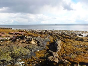 Scenic view of sea against cloudy sky