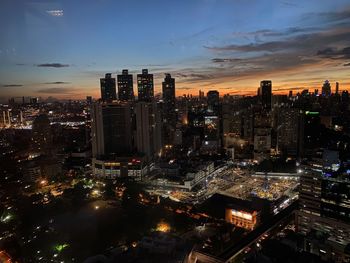 High angle view of illuminated buildings against sky at night