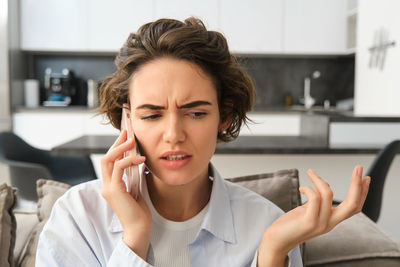 Portrait of young woman using phone