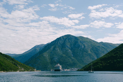 Scenic view of sea and mountains against sky