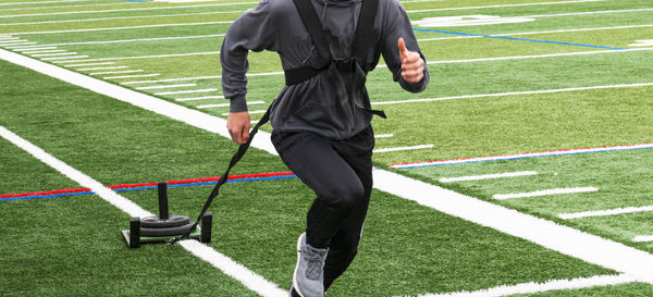 Low section of man running on grass