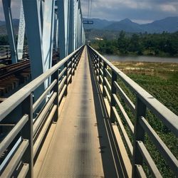 Empty footbridge against sky