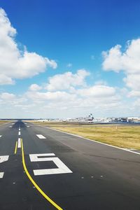 Airplane on runway against sky