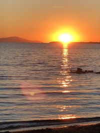 Scenic view of sea against romantic sky at sunset