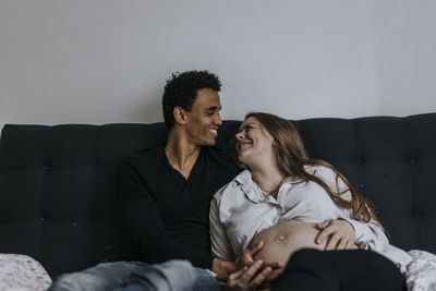 Pregnant woman with partner in bed