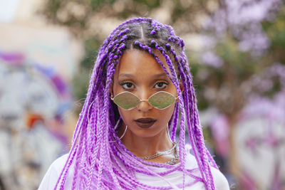 Portrait of woman with dyed hair wearing sunglasses