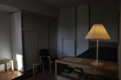 Empty chairs and table against wall at home