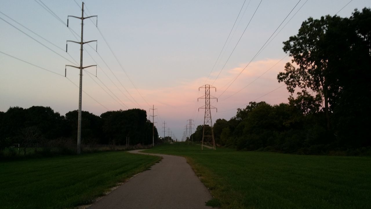 ROAD AMIDST FIELD AGAINST SKY AT SUNSET