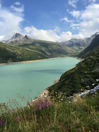 Scenic view of lake and mountains against sky